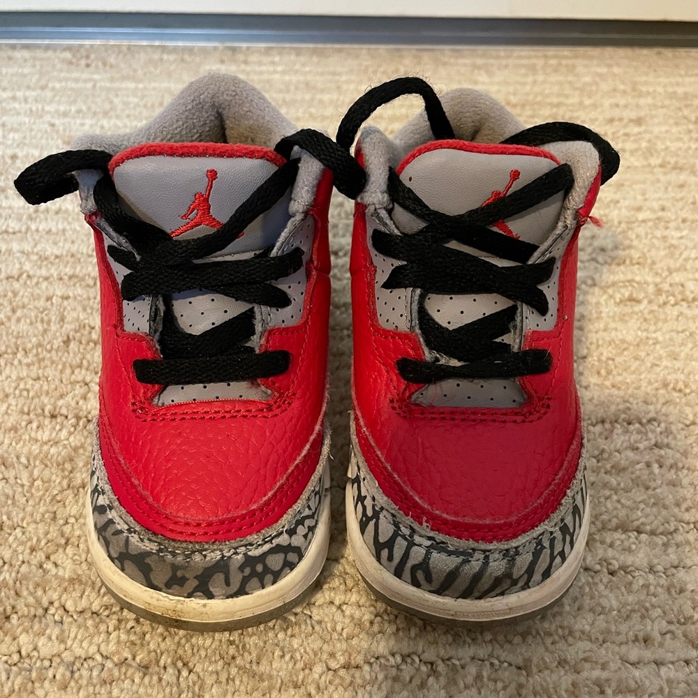 Red, black, and grey baby Jordan shoes